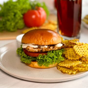 Copycat Chick-fil-A grilled chicken sandwich, served with waffle fries and iced tea.