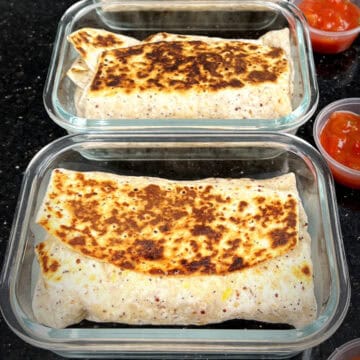 Ham & egg breakfast burritos in glass meal prep containers.